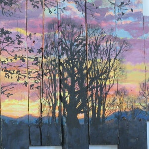 May include: A painting on wooden panels depicting a sunset scene with silhouetted trees. The sky is painted in shades of pink, purple, and yellow, with a hint of orange at the horizon. The trees are black and appear to be in a forest setting.