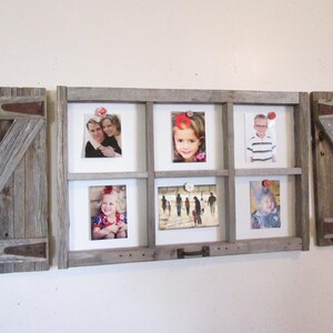 May include: A rustic wooden picture frame with six photo openings, flanked by two wooden shutter-style panels. The frame holds various photos, and the shutters have metal hinges and diagonal wooden supports. The overall design is a farmhouse style.