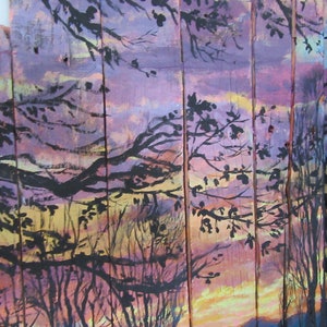 May include: A painting on wood panels depicting a sunset scene with silhouetted trees. The sky is painted in shades of purple, pink, and yellow, with a hint of orange at the horizon. The trees are black and create a dramatic contrast against the colorful sky.