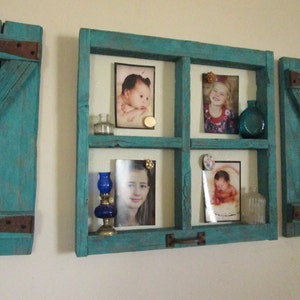 May include: A teal blue wooden picture frame with a window pane design. The frame has four compartments for displaying photos. The frame has a rustic, distressed look.