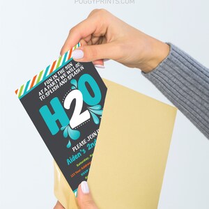 May include: A party invitation card with the text "H2O" in large teal letters, with the words "Fun in the sun at a party we will go, to splish and splash in" above. The invitation is being placed in a tan envelope.