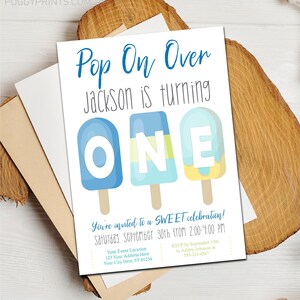 May include: A blue and yellow popsicle-themed birthday invitation for a boy turning one. The invitation says "Pop On Over Jackson is turning ONE" and includes details for the event, including the date, time, and RSVP information.