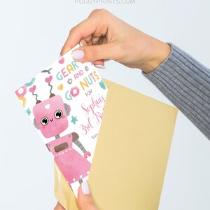 May include: A pink robot with a heart on its chest and a pink dress. The robot is surrounded by colorful gears, nuts, and bolts. The text "Gear and Go Nuts" is written in pink and yellow. The text "For Sophia's 3rd Birthday" is written in pink and blue.