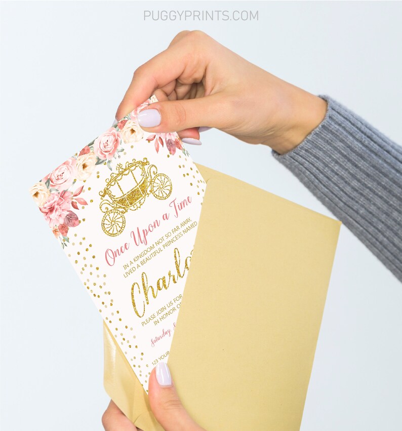 Op de afbeelding: Een witte uitnodiging met gouden glitter en roze bloemenaccenten. De uitnodiging luidt "Er was eens" en bevat de naam "Charlotte".