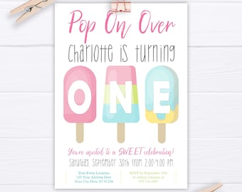 May include: A pink, blue and yellow popsicle-themed birthday party invitation for a girl turning one. The invitation says "Pop On Over Charlotte is turning ONE" and includes details about the party date, time, location and RSVP information.