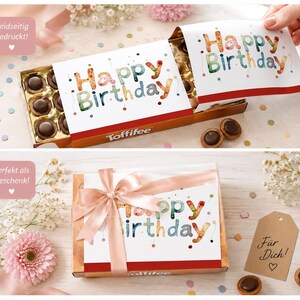 Pode incluir: Uma caixa de chocolates Toffifee com um cartão de "Feliz Aniversário". A caixa é decorada com uma fita rosa e uma etiqueta de presente que diz "Para você!" Os chocolates são redondos e castanhos escuros.