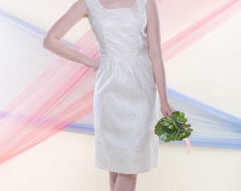 JOAN (Size 4): A simple knee length ivory & iridescent brocade shift dress with metal zipper up back.