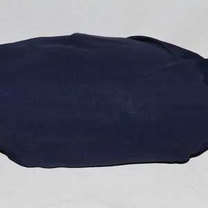 May include: A dark blue fabric pouch with two handles. The pouch is folded and appears to be empty.