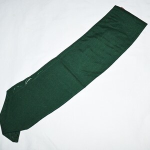 May include: A dark green fabric sash or belt, folded in half, with white stitching along the edges.