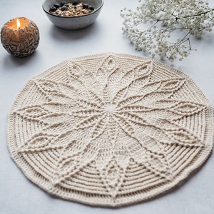May include: A beige crocheted doily with a starburst pattern. The doily is round and has a diameter of approximately 12 inches.