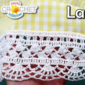 May include: White crochet lace trim with a delicate floral pattern. The trim is shown against a yellow and white gingham fabric. The text "Lace Trim" is visible in the image.
