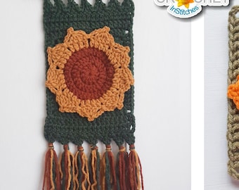 May include: Handmade crochet wall hanging and square featuring sunflower designs. The wall hanging is dark green with a sunflower in the center and tassels at the bottom. The square has a sunflower design with orange petals and a brown center.