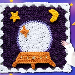 May include: A square crochet panel featuring a dark purple background with a large white circular crystal ball, an orange stand, and yellow star and crescent moon accents. The border is white with a scalloped edge. Text reads Jayda InStitches.