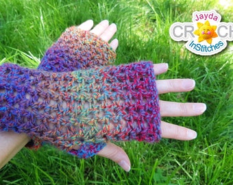 May include: A pair of colorful crochet fingerless gloves with a rainbow ombre pattern. The gloves are made with a lacy stitch and are shown against a green grassy background. The text "Jayda CROCHET InStitches" is visible in the upper right corner of the image.