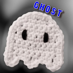 May include: White crocheted ghost with black eyes. The ghost is a handmade craft item. The word "GHOST" is written in blue letters above the ghost.