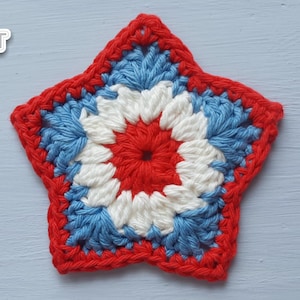 May include: A handmade, star-shaped crochet item in red, white, and blue. The center is red, surrounded by white, blue, and a red border. The item is likely a coaster or decorative piece. The logo "Jayda Crochet InStitches" is in the upper left.
