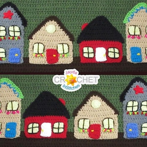 May include: A row of ten crocheted houses in various colors, including red, blue, green, and gray. Each house has a white door and windows, and some have additional details like a star or a wreath. The houses are arranged in a line on a green background. The text "Jayda Crochet InStitches" is visible in the center of the image.