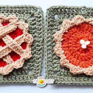May include: Two crocheted pie-themed squares. One has a red filling with a tan lattice crust, the other an orange filling with a tan crust and three white bobbles. Both are on green crocheted squares.