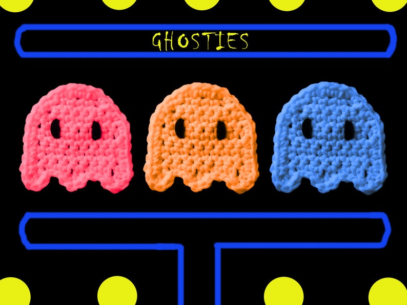 May include: Three crocheted ghost figures in pink, orange, and blue, arranged in a row with the word "GHOSTIES" above them.