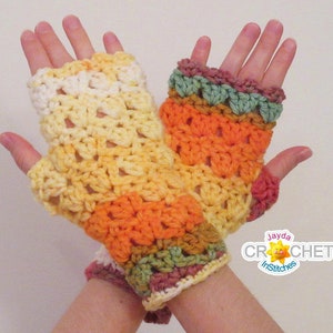 May include: A pair of colorful crocheted fingerless gloves with a multi-colored ombre design. The gloves are made with a variety of shades of yellow, orange, green, and red.