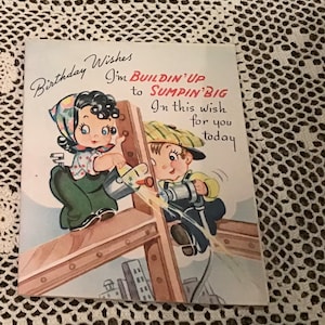 May include: A vintage birthday card featuring a cartoon illustration of two children building a structure. The girl is wearing a green dress and a red and white polka dot headscarf. The boy is wearing a yellow shirt and a green cap. The card reads "Birthday Wishes I'm buildin' up to sumpin' big In this wish for you today".