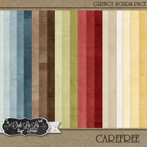 Op de afbeelding: Een verzameling getextureerde digitale papieren in verschillende kleuren, waaronder tinten blauw, bruin, groen en rood. De papieren hebben een distressed, grungy uitstraling. De woorden "Grungy Solids Pack" en "Carefree" zijn zichtbaar.