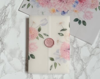 May include: A white envelope with a floral design and a pink wax seal. The envelope is decorated with pink, white, and blue flowers.
