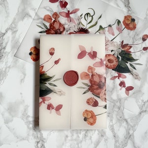 May include: A white envelope with a floral design in shades of pink and red. The envelope has a red wax seal with the word "Love" embossed on it.