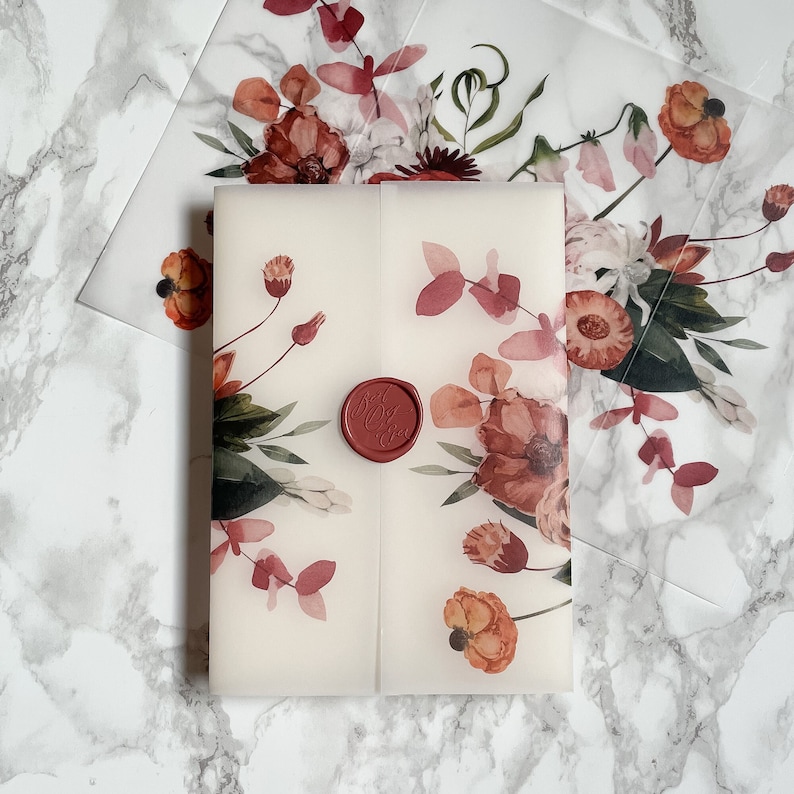 May include: A white envelope with a floral design in shades of pink and red. The envelope has a red wax seal with the word "Love" embossed on it.