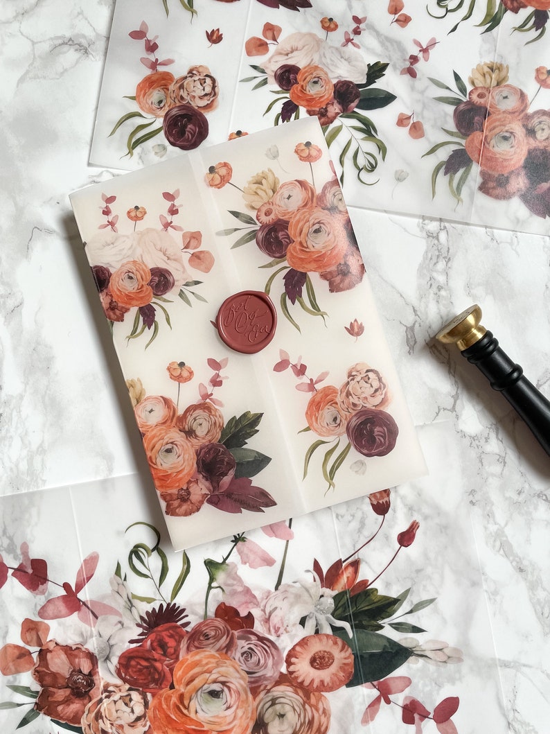 May include: A set of four translucent envelopes with a floral design in shades of orange, pink, and burgundy. The envelopes are sealed with a red wax seal.