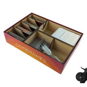 May include: A wooden game organizer for the board game Codenames. The organizer has compartments for the cards, the timer, and other game components. The organizer is made of wood and has a red, orange, and yellow gradient.