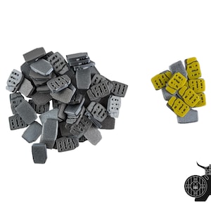 May include: A pile of gray and yellow foam tiles. The tiles are shaped like small rectangular blocks with a series of holes in them. The tiles are used for building and crafting.
