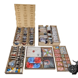 May include: Wooden board game organiser with multiple compartments and trays. Includes labelled sections for cards, tokens, and game pieces. Features a variety of colours and shapes, designed to hold board game components. The organiser is designed to keep game pieces organised.