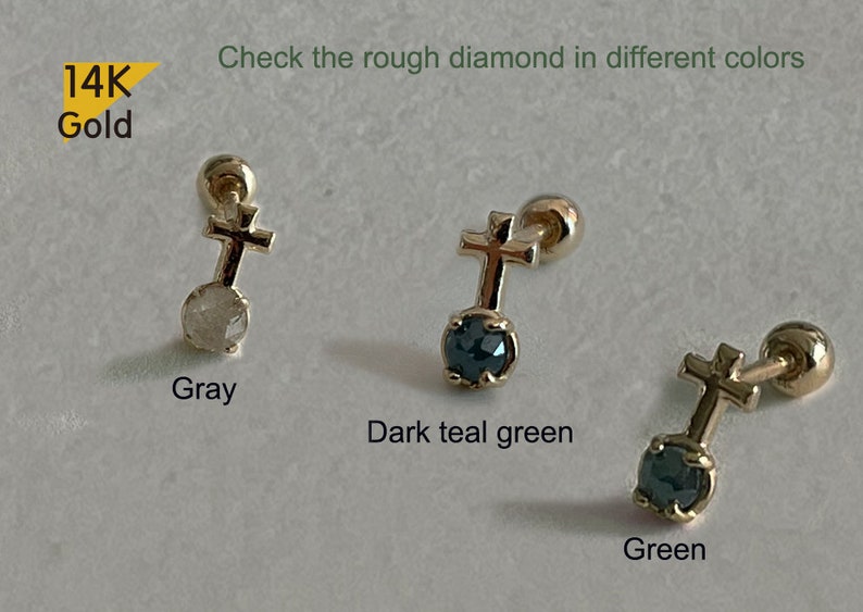 May include: Three 14K gold cross earrings with a rough diamond in the centre. The diamonds are grey, dark teal green, and green.
