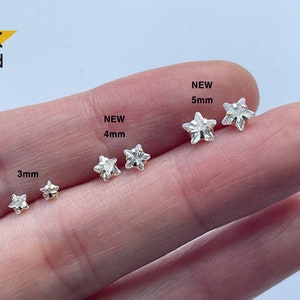 May include: Four sizes of 14K gold star-shaped earrings, 3mm, 4mm, 5mm, and NEW 5mm. The earrings are shown on a hand.