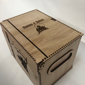 May include: A wooden box with a hinged lid and a handle. The lid is engraved with the words "Mansions of Madness" and a silhouette of a house.