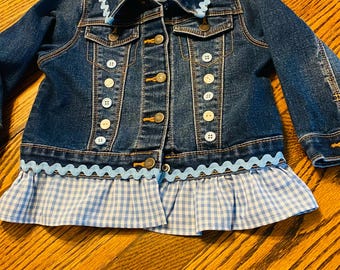 Girls Denim Shirt.   Toddler’s size 6-12 mos.   Denim accented with blue gingham.