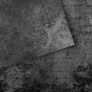 May include: A black and white textured background with a faded floral pattern. The background is made of paper and has a distressed look.