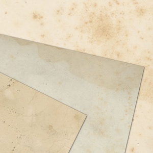 May include: Three pieces of textured, off-white paper with brown spots and stains. The paper is layered on top of each other, creating a triangular shape.
