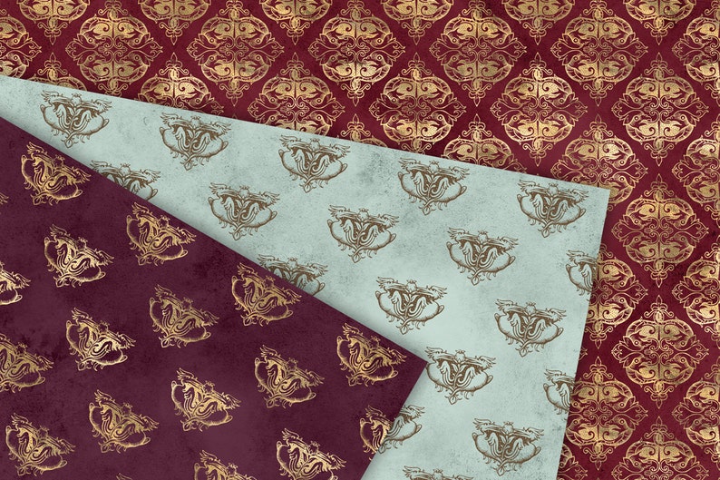 May include: Two patterned papers with a gold and burgundy design. The top paper is light blue with a gold pattern of a stylized bird. The bottom paper is burgundy with a gold pattern of a stylized flower.