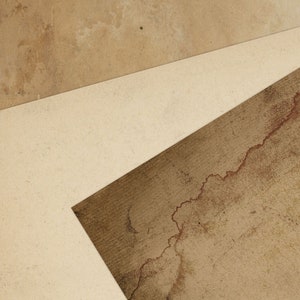 May include: A close-up of three pieces of textured paper, with a light brown, a medium brown, and a dark brown colour. The paper is layered on top of each other, creating a geometric pattern.