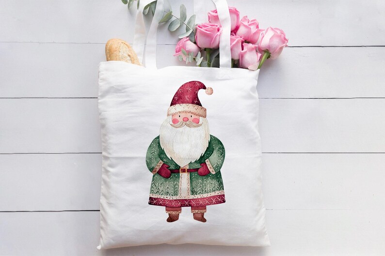 May include: White canvas tote bag with a red and green Santa Claus illustration. The Santa Claus is wearing a red hat, a green coat with white trim, and a white beard.