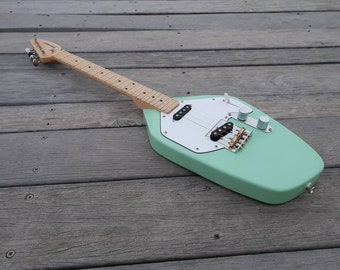Wisp electric ukulele. Baritone scale length 19". Dual pickup with 3 way selector.  Seafoam green. Maple fretboard with vintage tint.