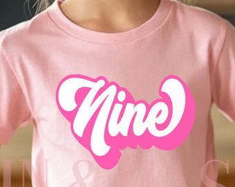 May include: A pink t-shirt with the word "Nine" in a pink retro font.