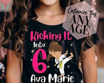 May include: A black t-shirt with a pink number 6, the words "Kicking It Into" and "Ava Marie" and a cartoon girl in a karate uniform kicking. The text "Customize This Any Age" is in a white box.