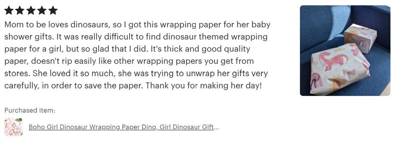 The image is a review of a dinosaur-themed gift wrapping paper, specifically the "Boho Girl Dinosaur Wrapping Paper Dino, Girl Dinosaur Gift...". The review is written in a text format, with a star rating at the top and a description of the product.