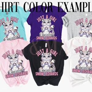 May include: Six t-shirts in different colors featuring a cartoon snow leopard with the text "Just a girl who loves snow leopards" in pink lettering.
