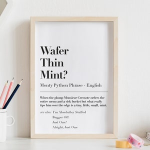 May include: A black and white printable wall art print with the text "Wafer Thin Mint?" and the phrase "Monty Python Phrase - English". The text below defines the phrase as "When the plump Monsieur Creosote orders the entire menu and a sick bucket but what really tips him over the edge is a tiny, little, small, mint."