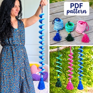 May include: A crochet spiral hanging decoration featuring a gradient of blue tones, topped with a loop and finished with a tassel at the bottom. The image includes text that reads PDF pattern, and displays multiple versions in blue, green, and pink.