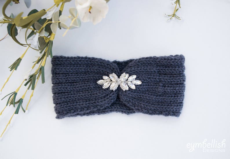 May include: A dark blue knitted headband with a silver rhinestone embellishment in the center.